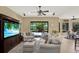 Living area with sliding glass doors to pool, stylish furniture, and a large entertainment center at 8420 Dunham Station Dr, Tampa, FL 33647