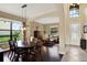 Open-concept living and dining areas with hardwood floors, stylish furniture, and ample natural light at 8420 Dunham Station Dr, Tampa, FL 33647