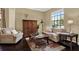 Comfortable living room featuring hardwood floors, stylish furniture, and a large window for natural light at 8420 Dunham Station Dr, Tampa, FL 33647
