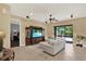 Living area with tile flooring, sliding glass doors to pool, stylish furniture, and a large entertainment center at 8420 Dunham Station Dr, Tampa, FL 33647