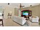 Living room with neutral paint, tile flooring, stylish furniture, and a large entertainment center at 8420 Dunham Station Dr, Tampa, FL 33647