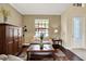 Comfortable living room featuring a large window, stylish furniture, and a decorative rug at 8420 Dunham Station Dr, Tampa, FL 33647