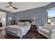Comfortable primary bedroom with hardwood floors, sitting area, and natural light at 8420 Dunham Station Dr, Tampa, FL 33647