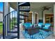 Inviting outdoor seating area with a spiral staircase, comfortable seating, and a decorative rug at 8420 Dunham Station Dr, Tampa, FL 33647
