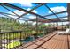 Large enclosed patio offering views of the pool, greenery and blue skies at 8420 Dunham Station Dr, Tampa, FL 33647