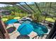 Aerial view of screened pool featuring a custom pool with waterfall and attached spa at 8420 Dunham Station Dr, Tampa, FL 33647