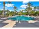 Beautiful community pool surrounded by palm trees and lounge chairs at 8420 Dunham Station Dr, Tampa, FL 33647