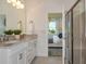 Modern bathroom with a double vanity, granite countertops, and a glass-enclosed shower at 9740 Redwood Heights Loop, Thonotosassa, FL 33592