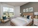 Bright bedroom features a decorative accent wall, large window, and stylish furnishings at 9740 Redwood Heights Loop, Thonotosassa, FL 33592