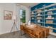 Bright home office with custom shelving, a large window, and a stylish desk for remote work at 9740 Redwood Heights Loop, Thonotosassa, FL 33592