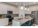 Spacious kitchen features granite countertops, stainless steel appliances, and barstool seating at the island at 9740 Redwood Heights Loop, Thonotosassa, FL 33592