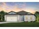 Charming one-story home featuring a two-car garage, well manicured lawn and tasteful landscaping at 9749 Redwood Heights Loop, Thonotosassa, FL 33592
