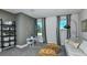 Bedroom room with grey colored wall and a small table and sofa, featuring stylish décor at 9754 Redwood Heights Loop, Thonotosassa, FL 33592