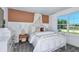 Well-lit bedroom with modern decor featuring a white bed, carpeted floor, and a white drawer at 9754 Redwood Heights Loop, Thonotosassa, FL 33592