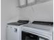 A modern laundry room with new side by side washer and dryer units at 9754 Redwood Heights Loop, Thonotosassa, FL 33592
