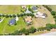 Aerial view of a landscaped property within a quiet community, featuring a pool and lush landscaping at 9916 Preakness Stakes Way, Dade City, FL 33525