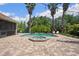 Beautiful backyard with a sparkling pool, lush tropical landscaping, and comfortable lounging areas at 9916 Preakness Stakes Way, Dade City, FL 33525