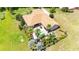 Aerial view of a backyard boasting a pool, lush landscaping, and patio area, perfect for outdoor relaxation at 9916 Preakness Stakes Way, Dade City, FL 33525