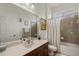 Bathroom vanity with sink, a large mirror, a toilet, and a shower with a glass door at 9916 Preakness Stakes Way, Dade City, FL 33525