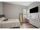 Well-lit bedroom with hardwood floors, neutral walls, a large window, and a desk area at 9916 Preakness Stakes Way, Dade City, FL 33525