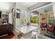 Cozy breakfast nook with white bench seating and a view of the outdoor patio and garden at 9916 Preakness Stakes Way, Dade City, FL 33525