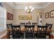 Elegant dining room with a large table, chandelier, and stylish decor for Gathering gatherings and entertaining at 9916 Preakness Stakes Way, Dade City, FL 33525