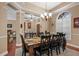 Spacious dining room with seating for six, a chandelier, and access to other living spaces at 9916 Preakness Stakes Way, Dade City, FL 33525