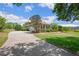 Well-maintained single-story home with a long driveway, mature landscaping, and a manicured lawn at 9916 Preakness Stakes Way, Dade City, FL 33525