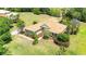 Beautiful single-story home featuring lush landscaping, a well-manicured lawn, and a welcoming front entryway at 9916 Preakness Stakes Way, Dade City, FL 33525