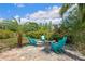 An inviting outdoor fire pit area with Adirondack chairs, perfect for relaxing evenings in the lush backyard at 9916 Preakness Stakes Way, Dade City, FL 33525