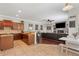 Modern kitchen with cherry cabinets, stainless steel appliances, and an open layout to living areas at 9916 Preakness Stakes Way, Dade City, FL 33525