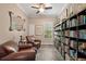 Cozy library with hardwood floors, built-in bookshelves, reading chairs, and natural light at 9916 Preakness Stakes Way, Dade City, FL 33525