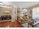 Open-concept living room leading to the dining area, featuring hardwood floors and ample natural light at 9916 Preakness Stakes Way, Dade City, FL 33525