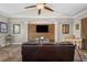 Inviting living room with a wood-paneled accent wall and comfortable leather sofa at 9916 Preakness Stakes Way, Dade City, FL 33525