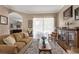 Comfortable living room with hardwood floors, neutral colors, and abundant natural light from large windows at 9916 Preakness Stakes Way, Dade City, FL 33525