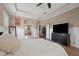 Spacious main bedroom with wood floors, panel molding, ensuite bath, and access to the library at 9916 Preakness Stakes Way, Dade City, FL 33525