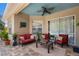 Charming outdoor patio with comfortable seating, a ceiling fan, and lush tropical plants at 9916 Preakness Stakes Way, Dade City, FL 33525