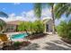 Beautiful pool with adjacent patio, tropical landscaping, and inviting outdoor space for relaxing and entertaining at 9916 Preakness Stakes Way, Dade City, FL 33525