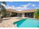 Inviting backyard pool with spa and patio offers a relaxing outdoor living space with plenty of room for seating at 9916 Preakness Stakes Way, Dade City, FL 33525