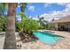 A pristine pool with spa, patio, and tropical landscaping creates a relaxing outdoor oasis at 9916 Preakness Stakes Way, Dade City, FL 33525