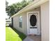 Inviting home entrance featuring a decorative storm door and brick walkway at 19232 Barred Owl Ct, Land O Lakes, FL 34638