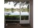 Scenic view from the screened lanai overlooking the serene community pond and well-manicured lawns at 19232 Barred Owl Ct, Land O Lakes, FL 34638