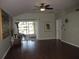 Bright living room featuring wood floors, neutral paint and lanai access at 19232 Barred Owl Ct, Land O Lakes, FL 34638