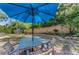 Charming backyard featuring a patio table with umbrella, providing a relaxing outdoor living space with a privacy fence at 4252 Sheldon Pl # 4252, New Port Richey, FL 34652