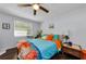 Cozy bedroom with a ceiling fan, dark wood floors, and bright bedding, creating a comfortable and inviting space at 4252 Sheldon Pl # 4252, New Port Richey, FL 34652