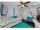 Charming bedroom with a coastal theme, featuring a daybed, bright blue accents, and stylish furnishings for a relaxing retreat at 4252 Sheldon Pl # 4252, New Port Richey, FL 34652