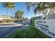 Community entrance with a sign, gate, and lush landscaping in a sunny, well-maintained community at 4252 Sheldon Pl # 4252, New Port Richey, FL 34652