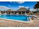 Gorgeous community pool featuring crystal blue water, a covered seating area and a meticulously maintained brick surround at 4252 Sheldon Pl # 4252, New Port Richey, FL 34652