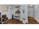 Cozy dining area adjacent to kitchen, featuring hardwood floors, bar pass-through, and beach decor at 4252 Sheldon Pl # 4252, New Port Richey, FL 34652