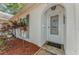 Close up of the front door featuring an arched entry with stylish mulch beds and decorative shutters at 4252 Sheldon Pl # 4252, New Port Richey, FL 34652